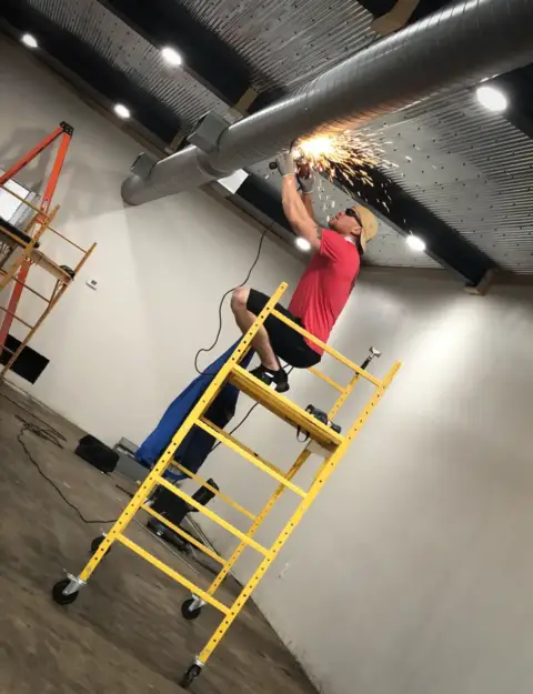 Performing electrical work.